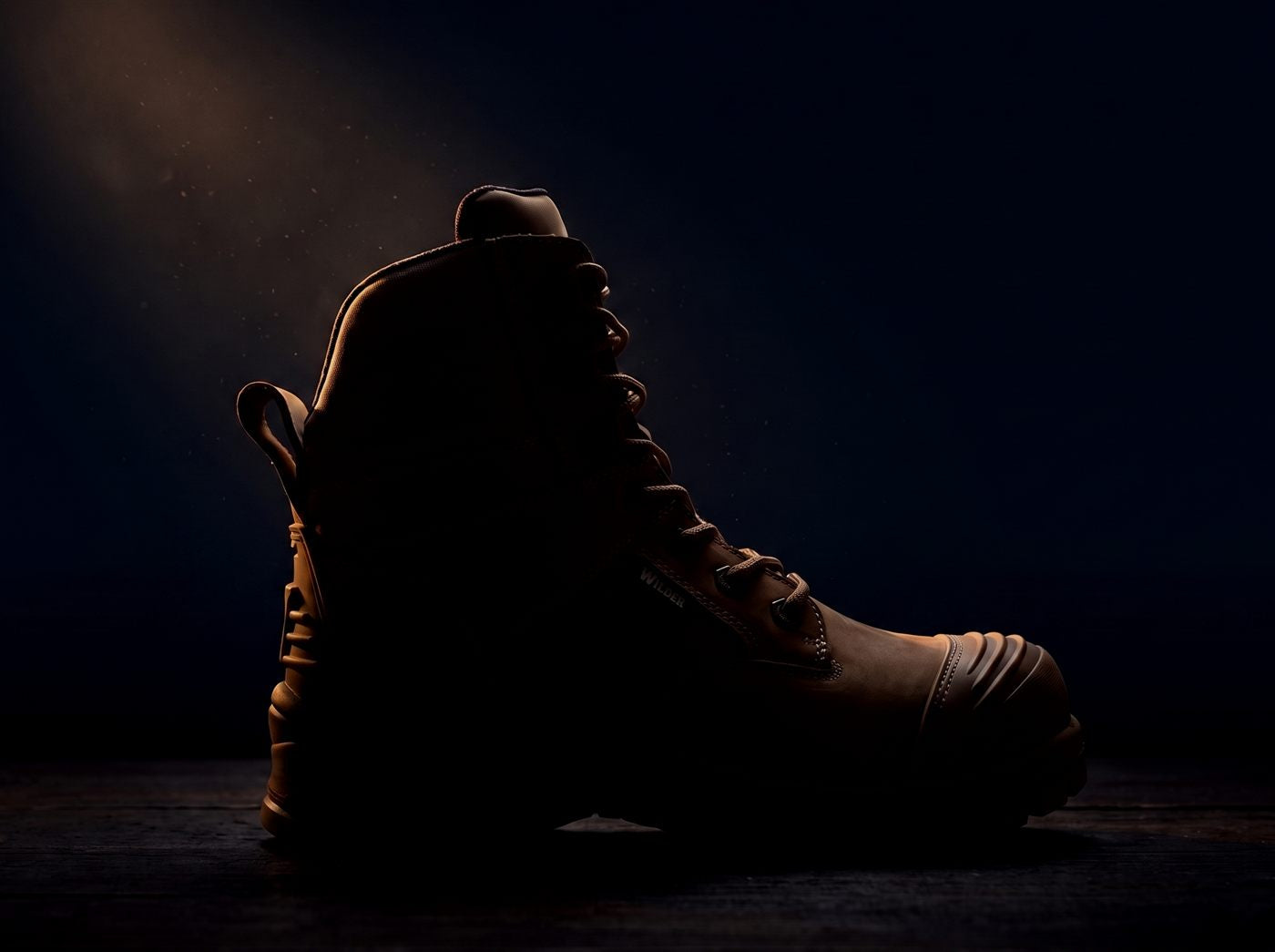 Wilder work boot, mostly hidden in shadow — full reveal at launch